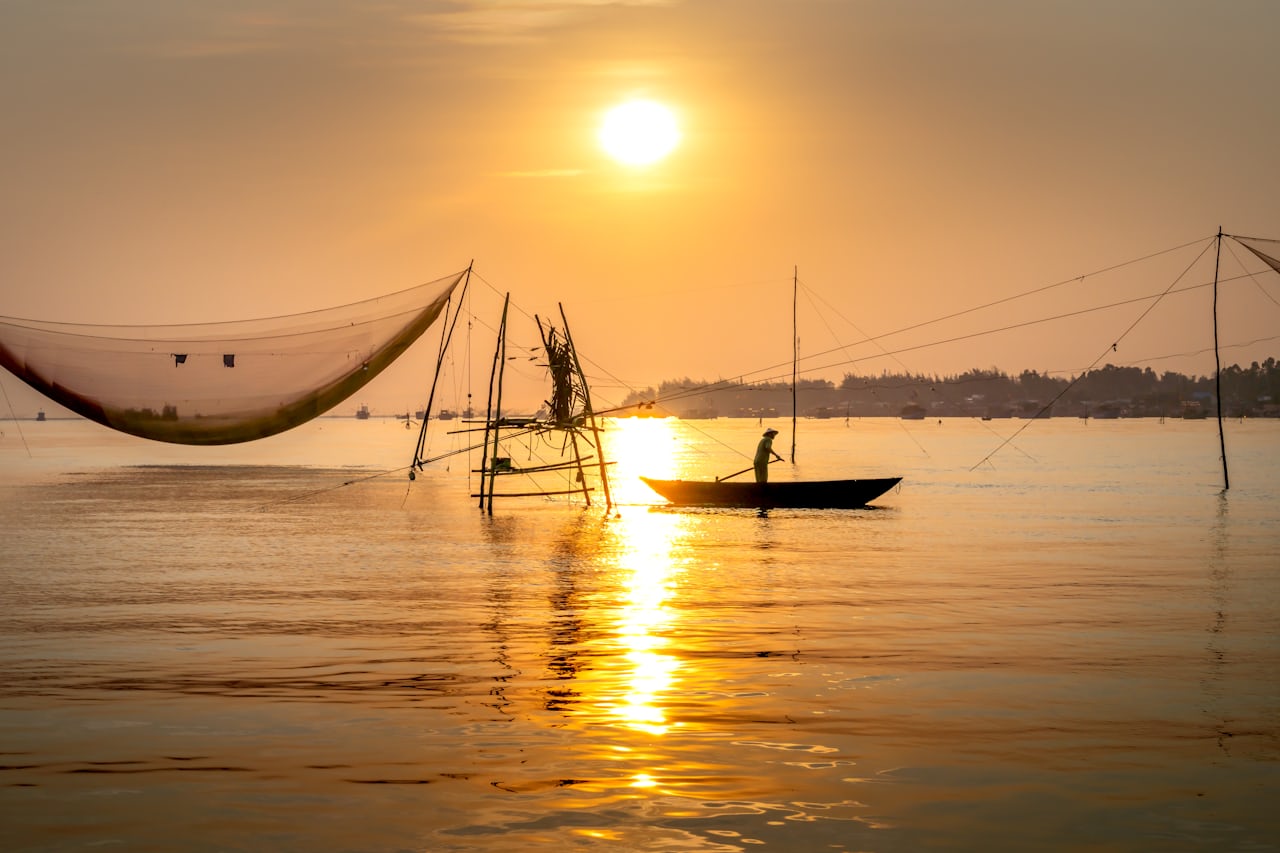 Fishing boat on Florida Gulf Coast water at golden sunset
