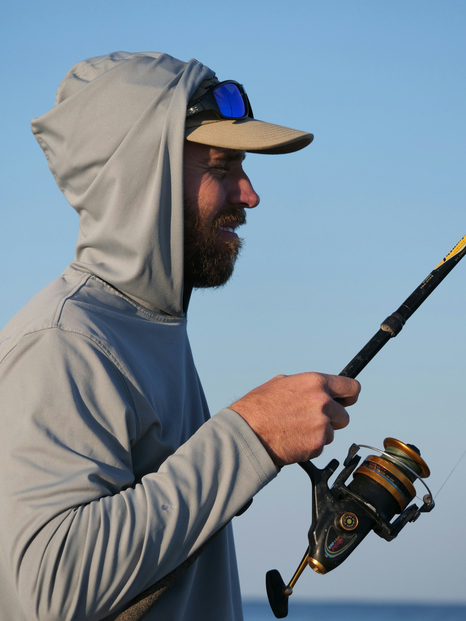 Angler fighting a fish with a spinning rod