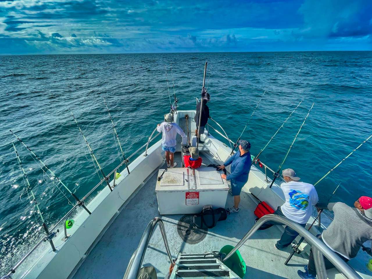 Anglers on an offshore sport fishing charter in blue water