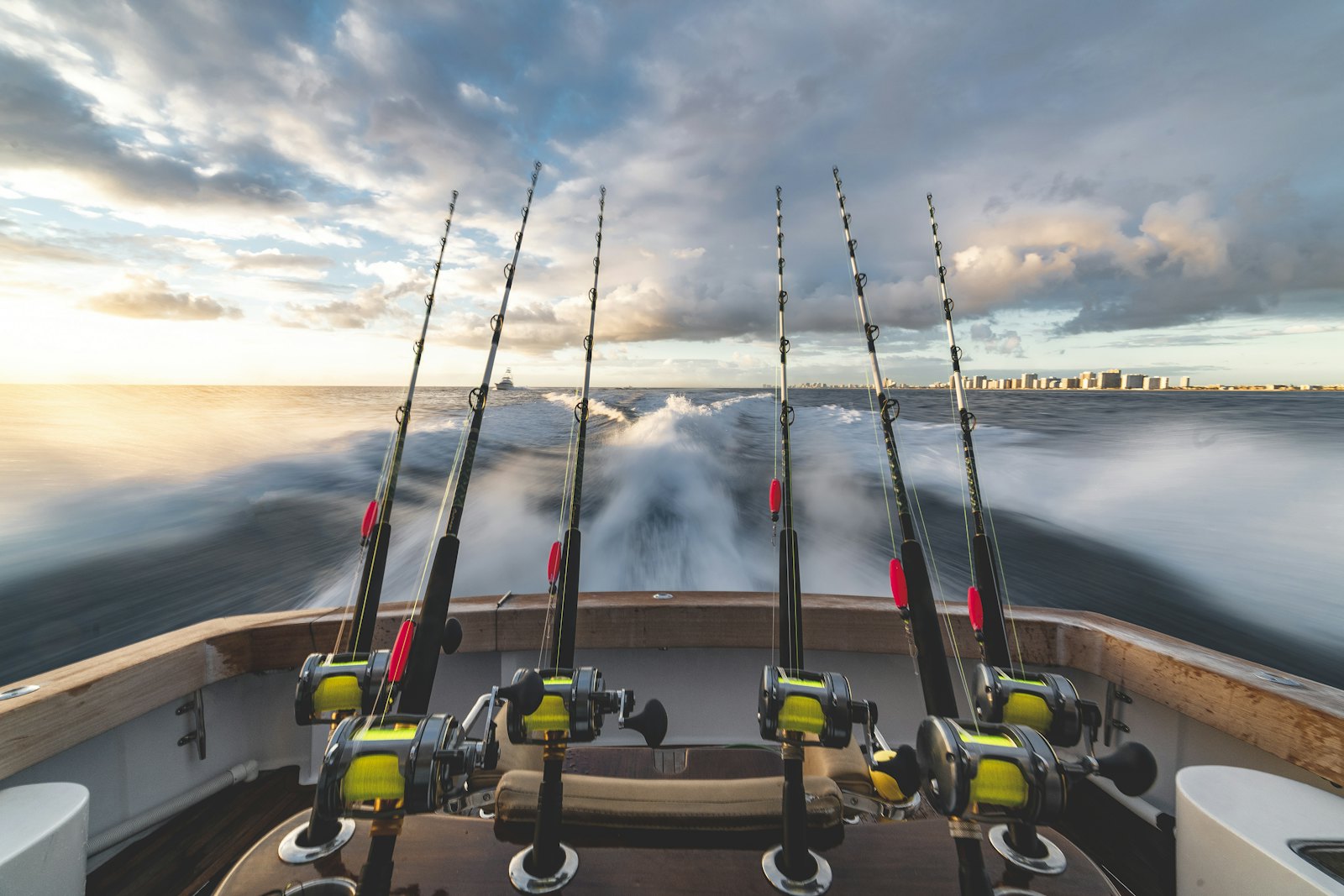 Trolling rods on a sport fishing boat at sunrise