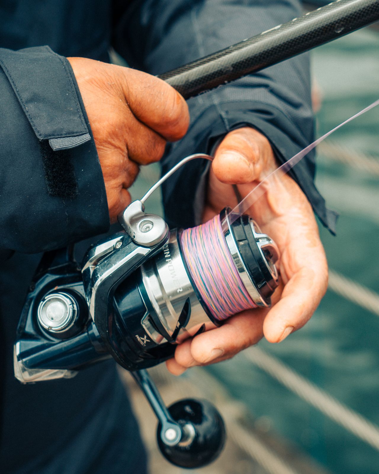 Multicolor braided fishing line loaded on a saltwater spinning reel spool